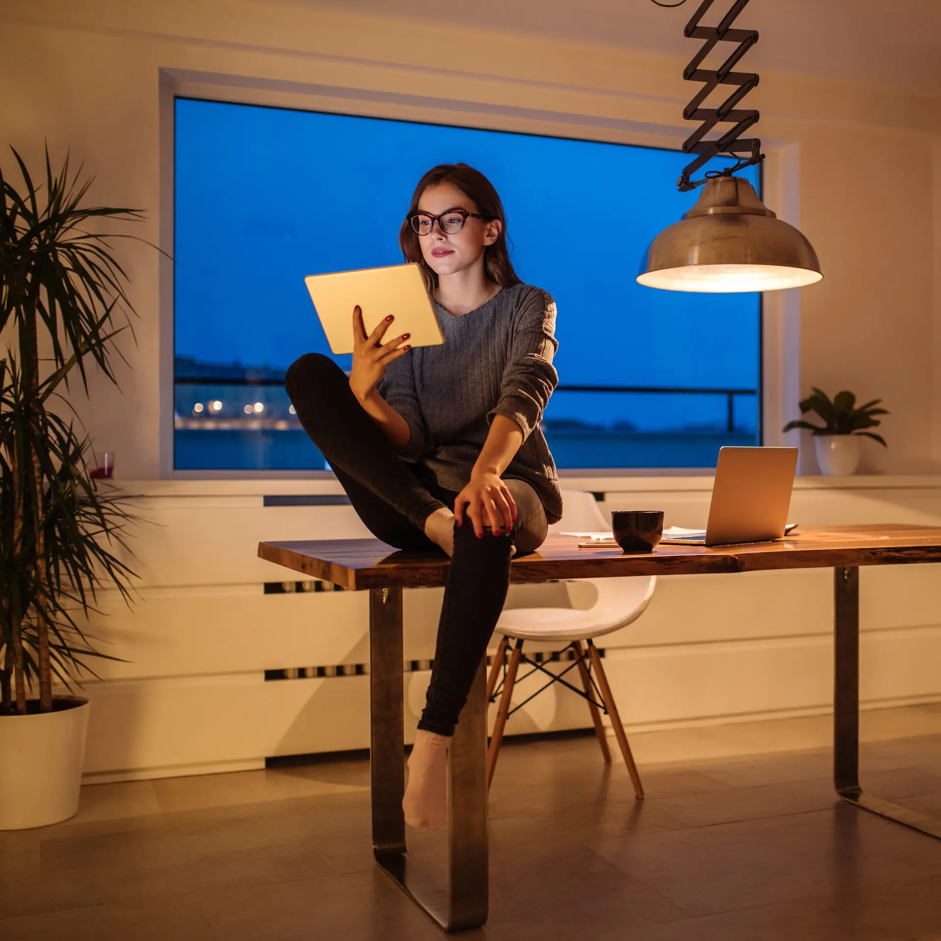 An entrepreneur working with a tablet in the evening